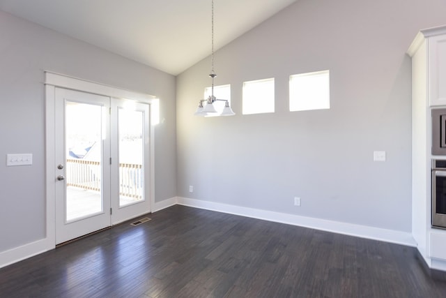 unfurnished dining area featuring dark hardwood / wood-style flooring and vaulted ceiling