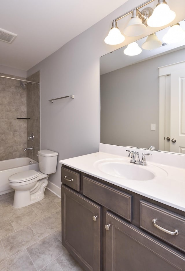 full bathroom featuring vanity, tiled shower / bath combo, and toilet