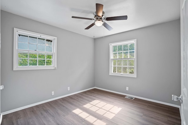 empty room with wood-type flooring and ceiling fan