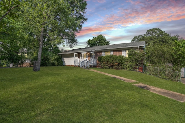 single story home featuring a lawn