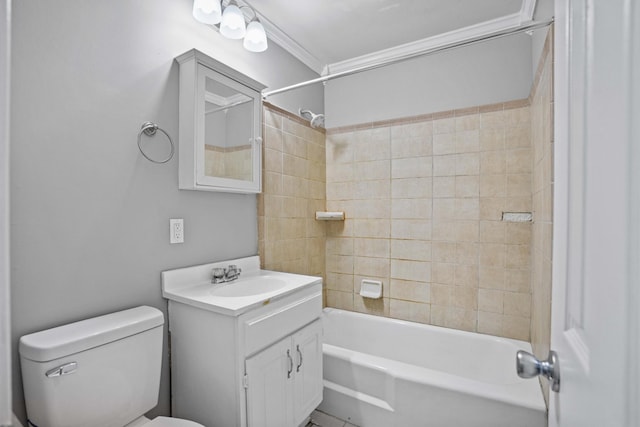 full bathroom with vanity, ornamental molding, toilet, and tiled shower / bath