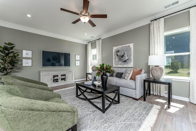 living room featuring crown molding, ceiling fan, and light hardwood / wood-style floors