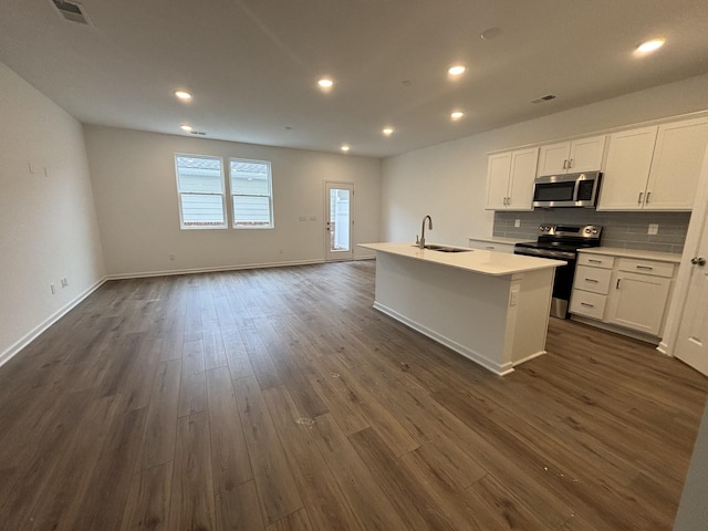 kitchen featuring white cabinetry, sink, stainless steel appliances, and a center island with sink