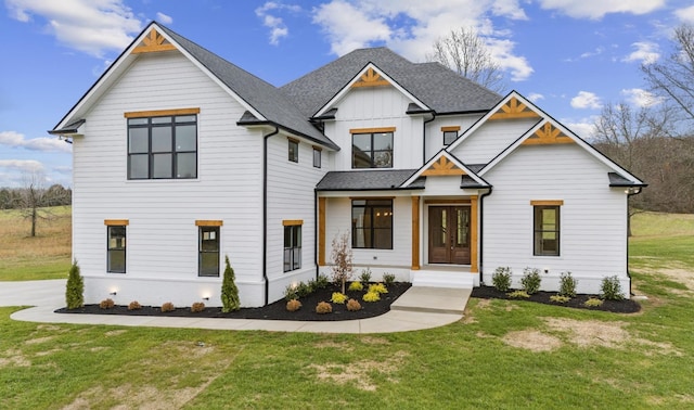 modern inspired farmhouse with a front lawn