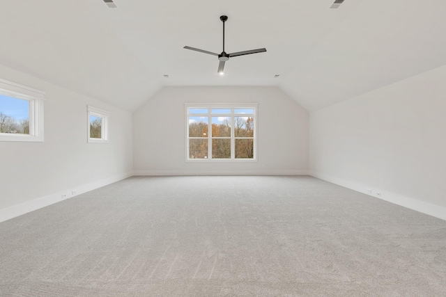 bonus room with vaulted ceiling, light carpet, and ceiling fan