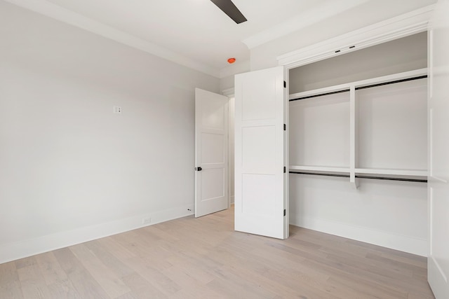 unfurnished bedroom with ceiling fan, two closets, and light wood-type flooring