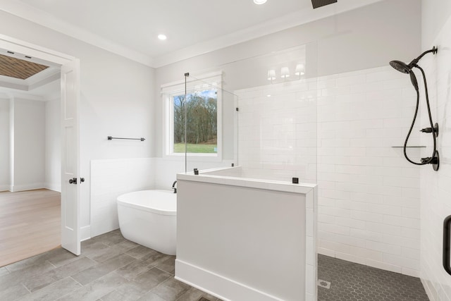 bathroom with ornamental molding, plus walk in shower, and tile walls