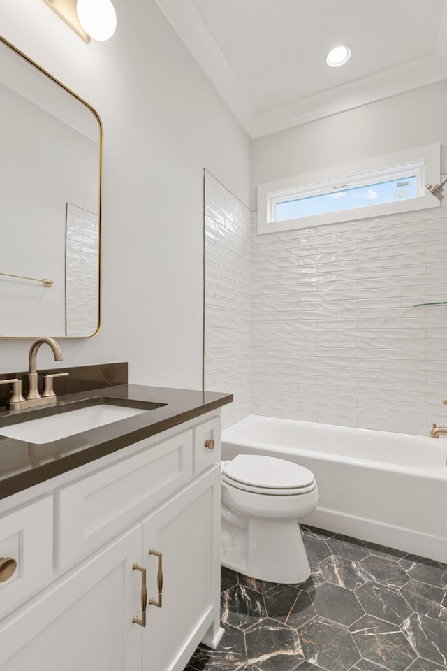 full bathroom with vanity, tiled shower / bath, crown molding, and toilet