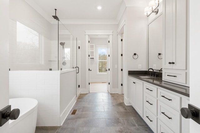 bathroom featuring ornamental molding, vanity, and independent shower and bath