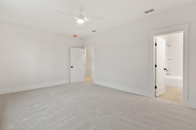 empty room featuring ceiling fan and light carpet