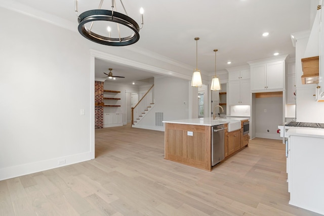 kitchen featuring sink, a center island with sink, light wood-type flooring, stainless steel dishwasher, and white cabinets