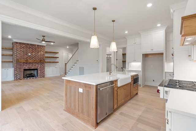 kitchen with white cabinetry, sink, a kitchen island with sink, and stainless steel appliances