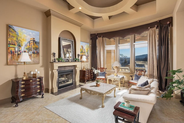 tiled living room with coffered ceiling and a tile fireplace