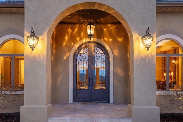 view of exterior entry featuring french doors