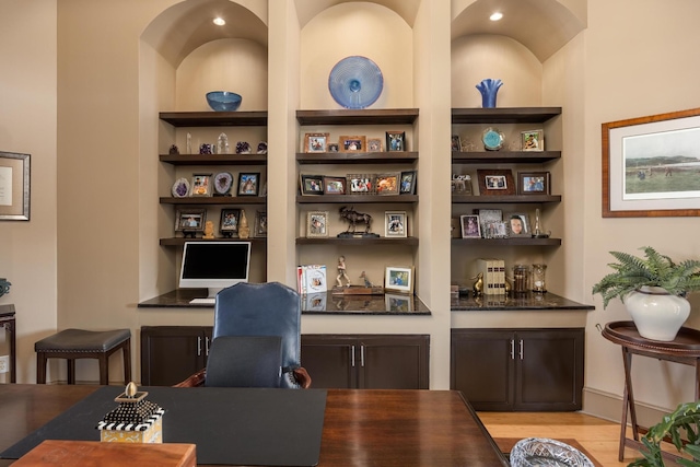 office area featuring built in shelves and light hardwood / wood-style flooring