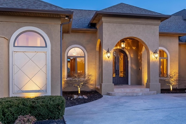 view of exterior entry featuring french doors