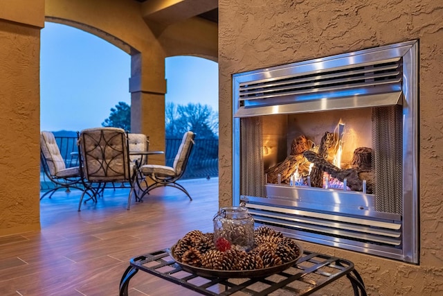 patio terrace at dusk with an outdoor fireplace