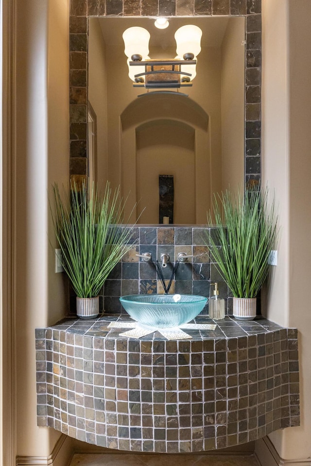 interior details with vanity and a notable chandelier