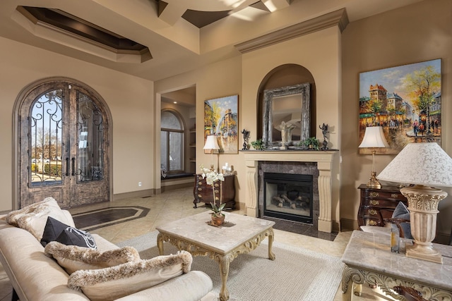 sitting room with a fireplace and light tile patterned floors