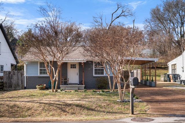 view of front facade featuring a carport and a front yard