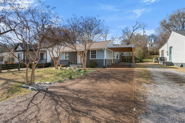 single story home featuring a carport