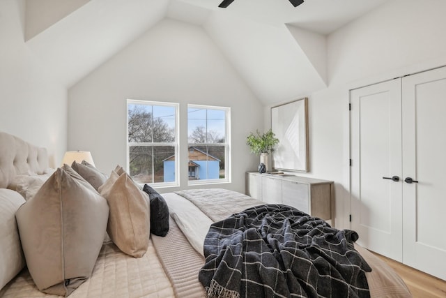 bedroom featuring high vaulted ceiling, ceiling fan, and a closet