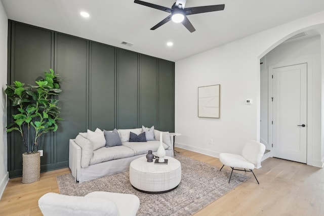 living room with ceiling fan and light wood-type flooring