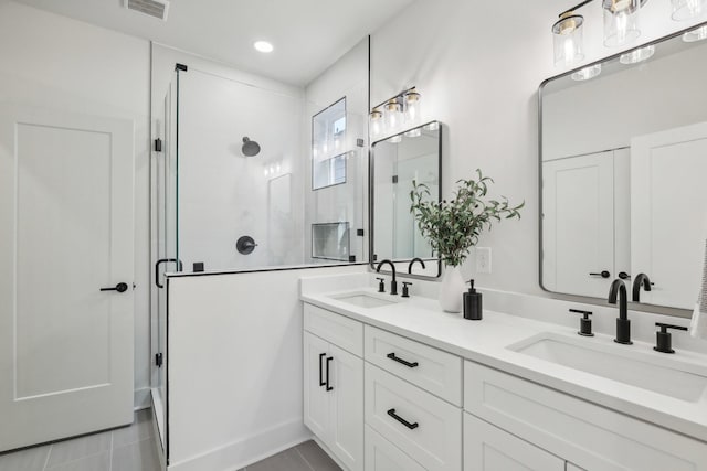 bathroom featuring vanity, tile patterned flooring, and a shower with door