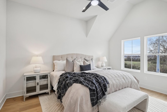 bedroom with vaulted ceiling, ceiling fan, and light wood-type flooring