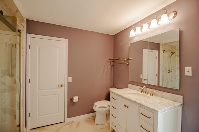 bathroom with vanity, an enclosed shower, and toilet