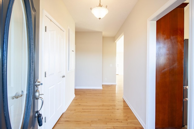 hallway with light hardwood / wood-style flooring