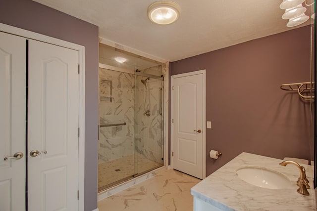 bathroom with vanity and a shower with door