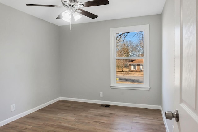 spare room featuring hardwood / wood-style flooring and ceiling fan