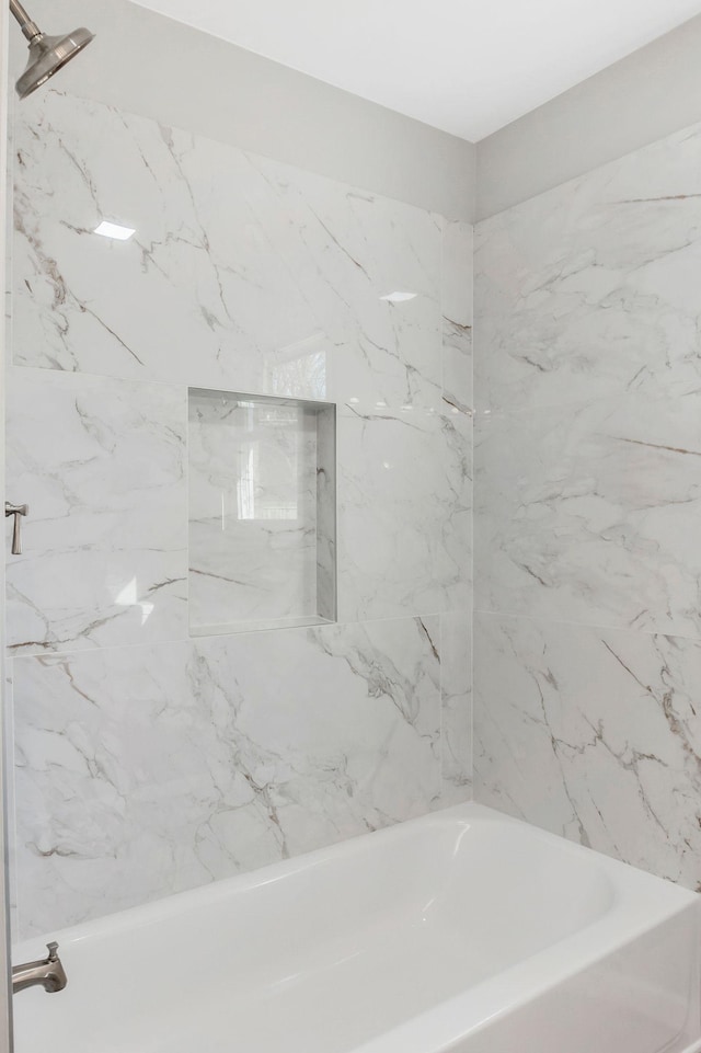 bathroom featuring washtub / shower combination