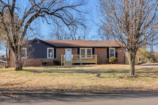 single story home with a deck and a front lawn