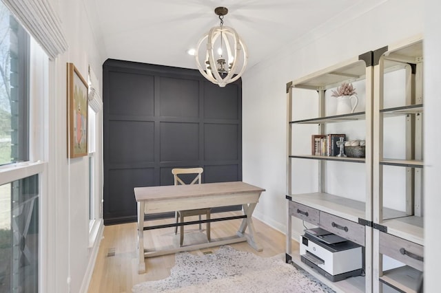 office featuring ornamental molding, a chandelier, and light wood-type flooring