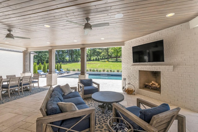 view of patio / terrace featuring an outdoor brick fireplace and ceiling fan