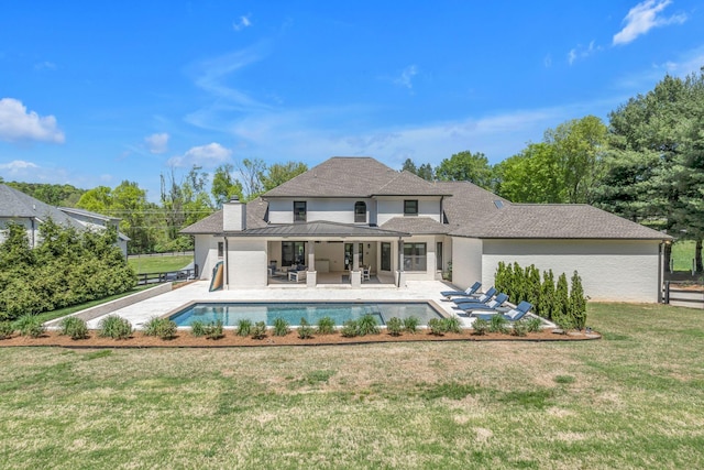 back of house with a yard and a patio area