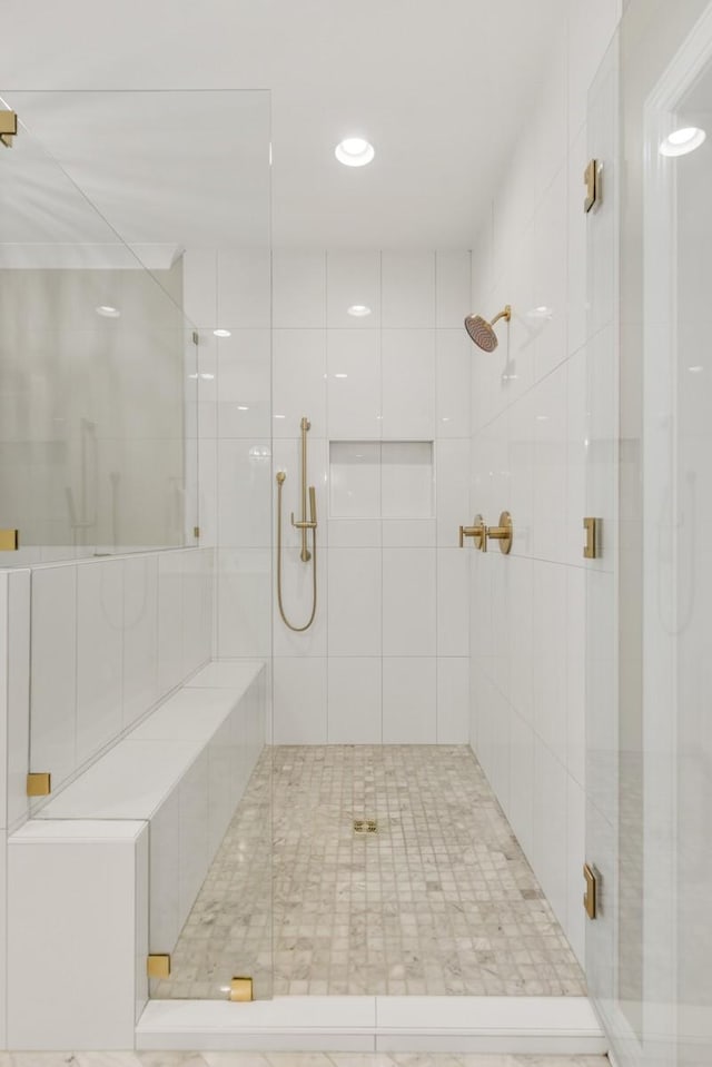 bathroom featuring a shower with door