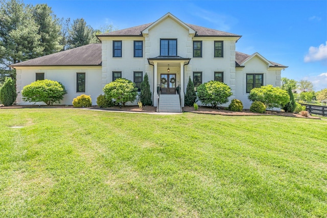 colonial home featuring a front yard