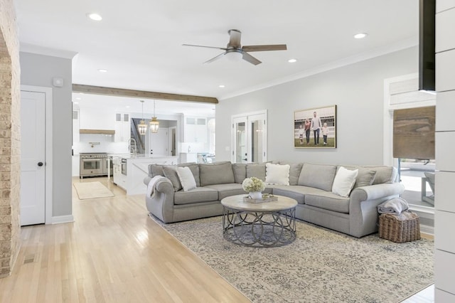 living room with french doors, ornamental molding, ceiling fan, and light hardwood / wood-style flooring