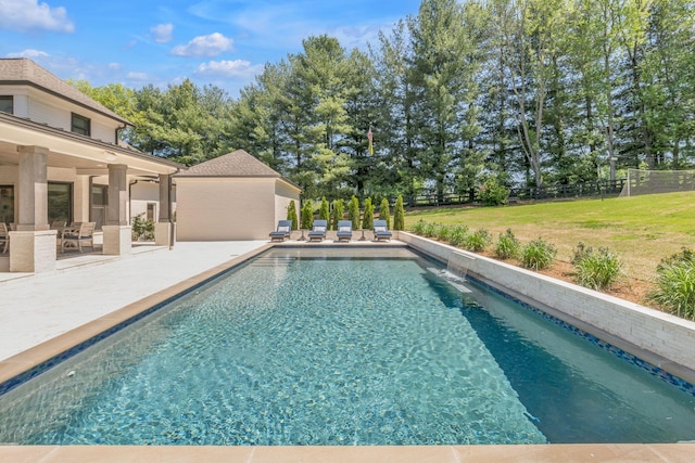 view of pool with a yard and a patio