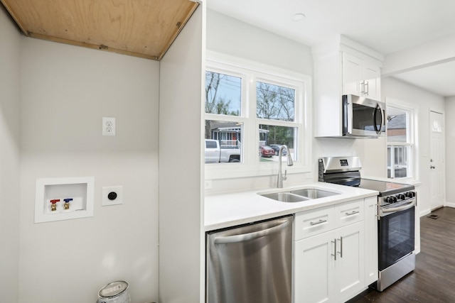 kitchen featuring stainless steel appliances, sink, white cabinets, and dark hardwood / wood-style floors