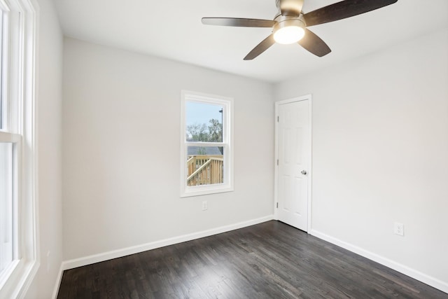 spare room featuring dark hardwood / wood-style floors and ceiling fan