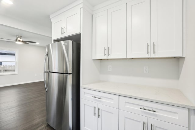 kitchen with white cabinetry and stainless steel fridge