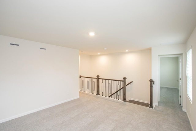 spare room featuring light colored carpet