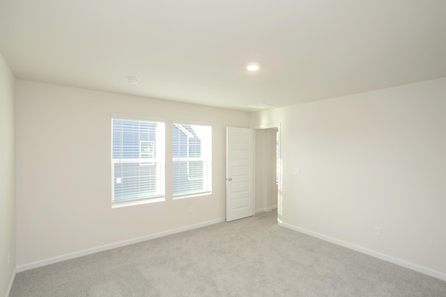 unfurnished room with light colored carpet