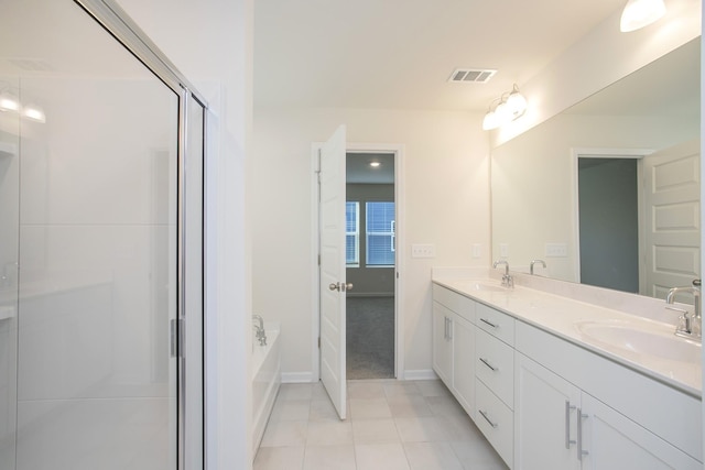 bathroom with vanity, tile patterned flooring, and a bathing tub