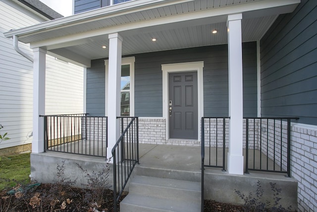 view of exterior entry with covered porch