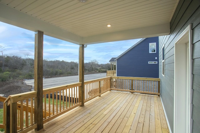 wooden terrace featuring a water view